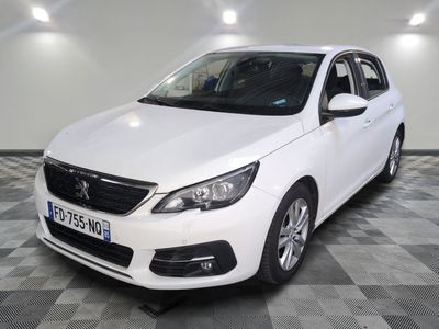 the white car is parked on a checkered floor in the garage