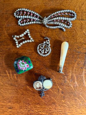 a wooden table topped with assorted jewelry and a baseball bat