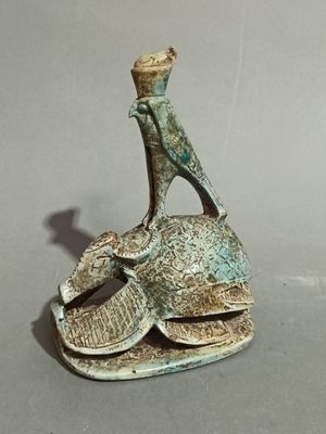 statue of a man on a turtle with a hat on his head