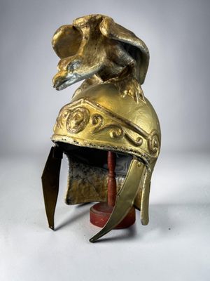 an image of a golden helmet with an elephant ' s head on it