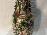 a vase that is sitting on a white surface