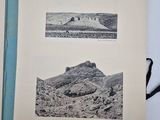 an old book opened to show two pictures of a desert landscape