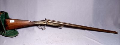 an old gun with a wooden handle and a green case