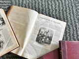 three old books sitting on the floor next to each other