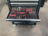 a tool cart with tools on it in a garage