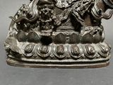 a statue of a man riding a horse with a bird on it