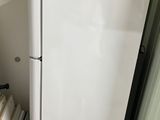 a refrigerator and a freezer in a small room