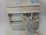 a toothbrush and toothpaste holder on a white surface