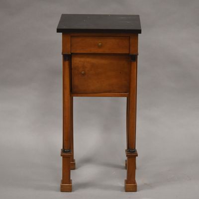 an image of a small wooden table with a black top