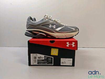 the under armour shoes are on top of a box