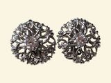 pair of silver tone earrings with crystal stones on a white background