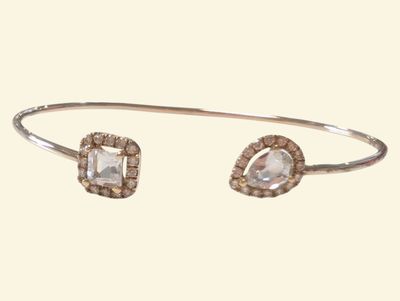 a close up of a bracelet with a white stone on it