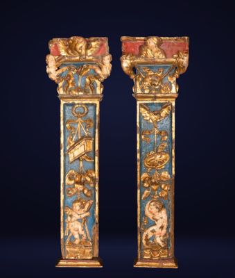 pair of gold and blue painted columns with figures on them