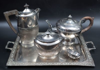 a silver tray with a silver tea set on it