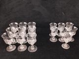 several clear wine glasses sitting on top of a black table