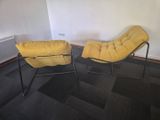 two chairs that are sitting in a room together