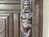 a close up of a wooden door with carvings on it