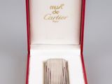 an image of a silver cigarette case in a red box