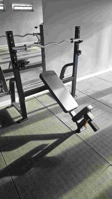 a black and white photo of a bench in a gym