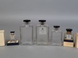 several bottles of different sizes and shapes are lined up on a table