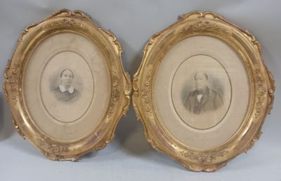 two framed pictures of a man and a woman in a gold frame