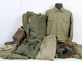 a pile of military clothing on a white table