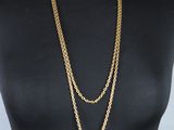 a mannequin torso with a gold chain necklace on it