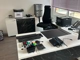 a desk with a laptop, monitor, keyboard, mouse and other items on it