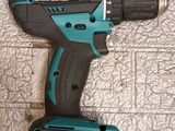 a close up of a cordless drill on a tile floor