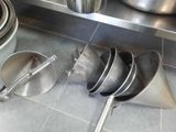 many pots and pans on the counter in the kitchen