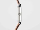a close up of a watch on a white surface with a brown strap