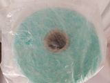 a roll of blue yarn wrapped in a plastic bag