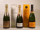 three bottles of champagne sitting next to each other in front of a box