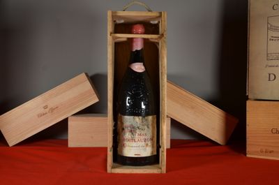 a bottle of wine in a wooden box on a table