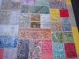 a patchwork rug with many different colors on it