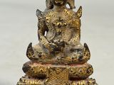 an image of a statue of a buddha sitting on top of a table