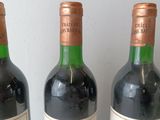 three bottles of wine that are sitting on a table