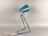 an image of a blue table lamp on a white surface