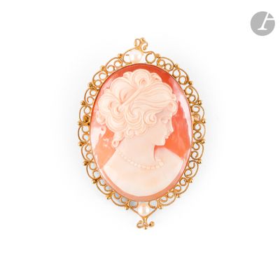 a close up of a woman ' s face in a gold broocher