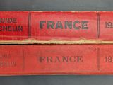 two red books sitting on top of each other on a table