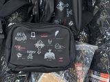 a black bag with a lot of items inside of it