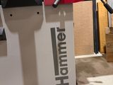 a machine that is cutting a piece of wood on a table
