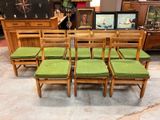 many chairs and a table in a room with pictures on the wall