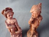 two figurines that are sitting on a table