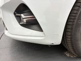 a close up of a car ' s front bumper with a flat tire