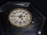 a clock that is in a glass case on a table