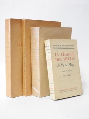 three books sitting on top of each other on a white surface