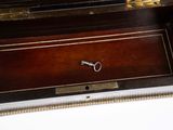 a wooden box with a key in it on a table