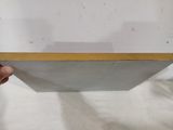 a person holding a piece of white paper with a gold edge