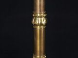 an antique brass table lamp on a black background with a black background